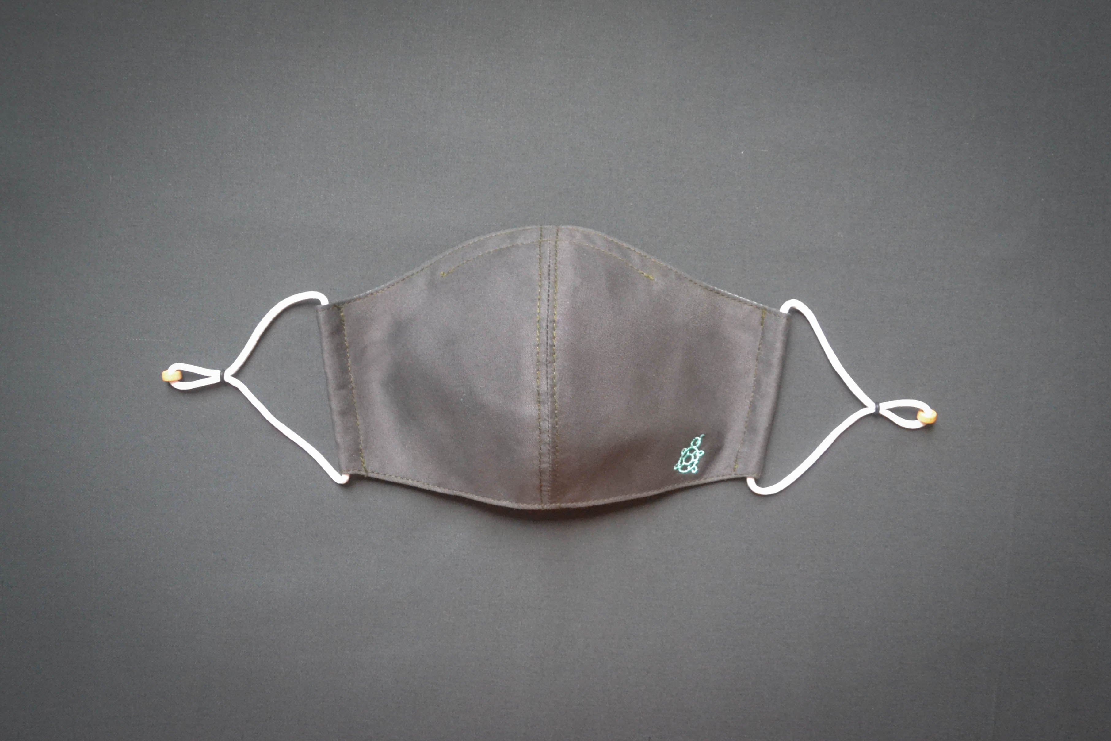 Turtle Mask 2.1 Beluga Grey- is made with 100% cotton fabric, which makes our masks very durable, sustainable and fully biodegradable.  The ear adjusters have been redesigned and are now more durable. In addition, the mask comes with a new inner sleeve to house a nose bridge wire for better fitment and comfort. Most importantly, Turtle Mask 2.1 is now machine washable when washed in a delicates laundry bag with cold water.